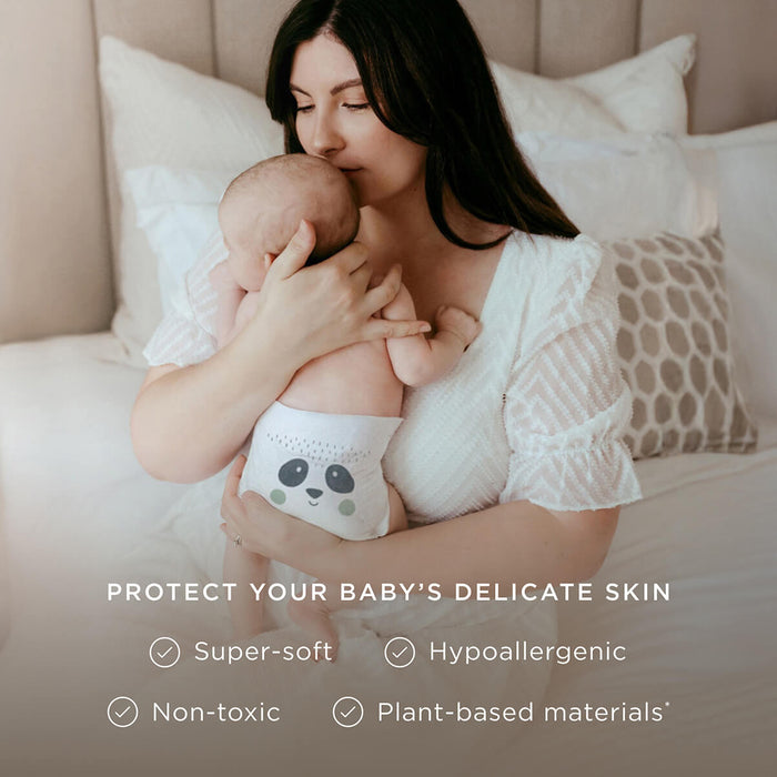 Mum holding baby wearing a Kit & Kin super-soft plant-based nappy - hypoallergenic and kind to baby’s skin