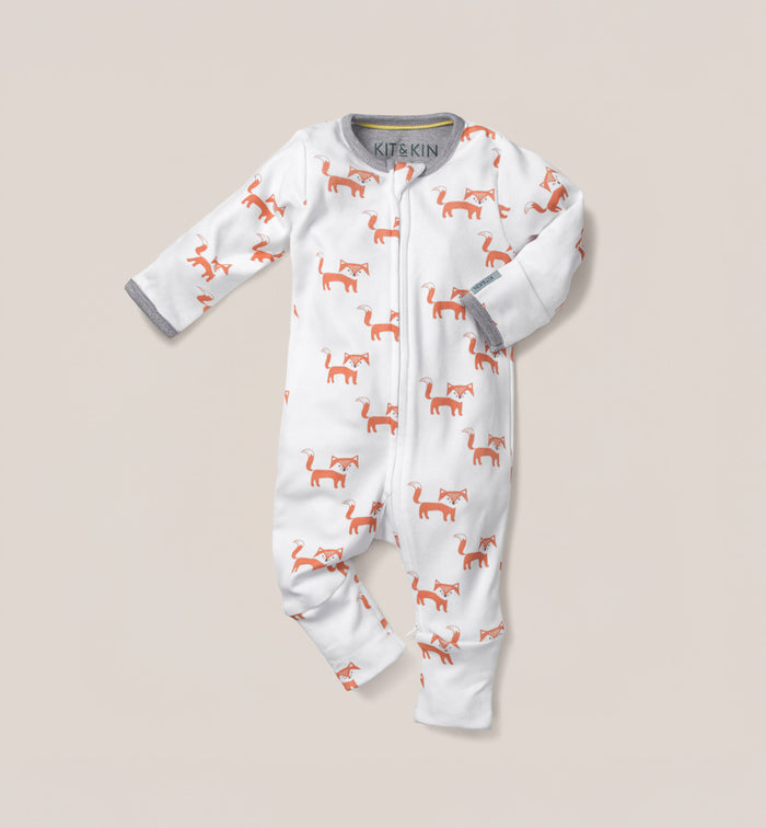 This Kit & Kin fox print baby all-in-one is made from GOTS-certified organic cotton, perfect for keeping newborns comfortable and cosy.