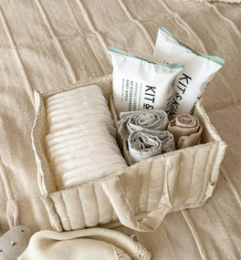 A nappy caddy containing two packs of Kit & Kin organic aloe vera wipes for sensitive skin 