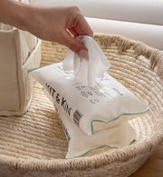 A hand pulling out a Kit & Kin eco friendly biodegradable baby wipes
