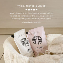Customer review praising Kit & Kin laundry bundle for removing stains, softening fabrics, and being safe for children’s sensitive skin