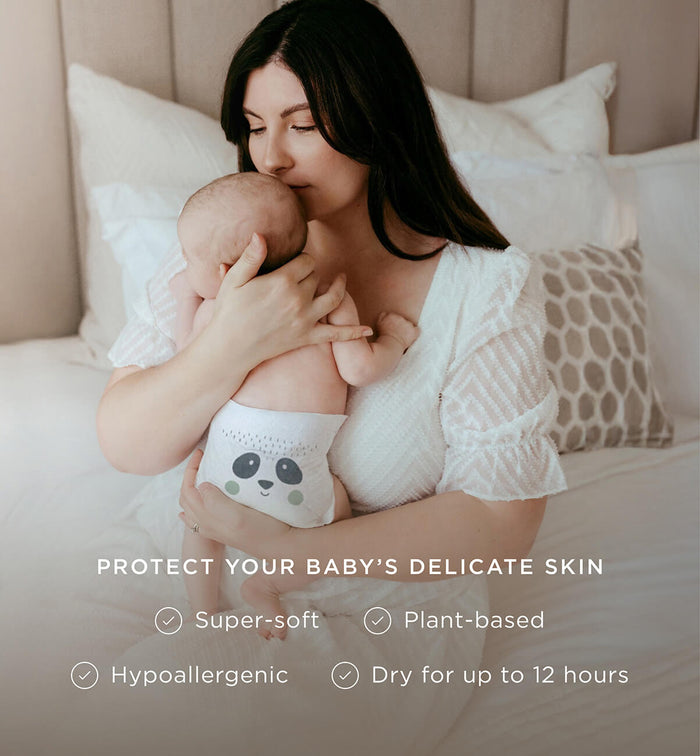 Mum holding baby wearing a Kit & Kin super-soft plant-based eco nappy - hypoallergenic and kind to baby’s skin